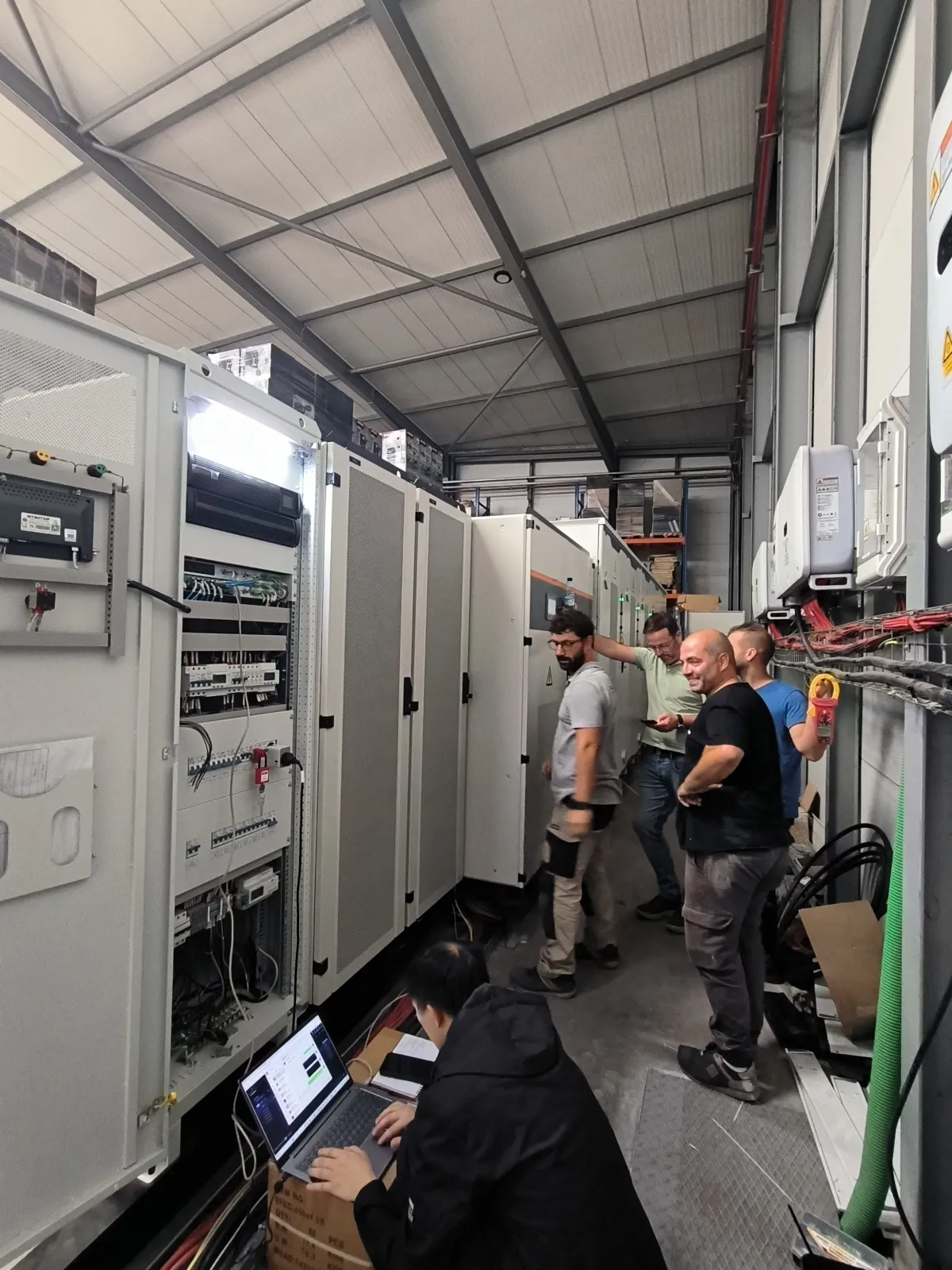 Hua Power engineers commissioning a C&I battery storage system and configuring the EMS