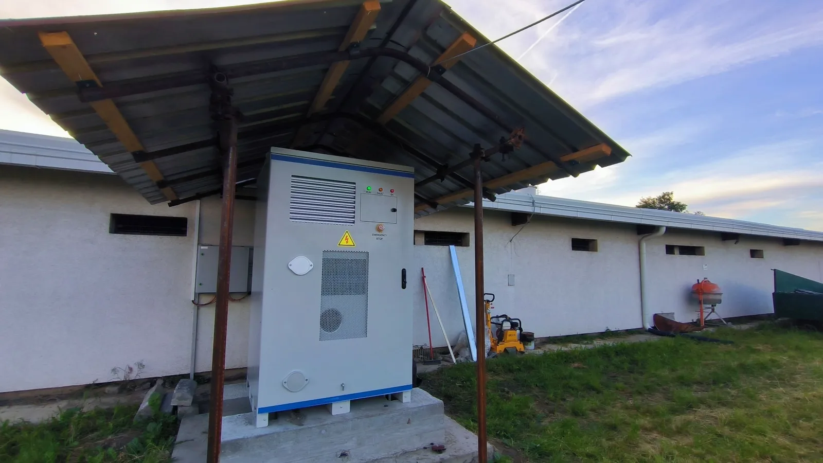 HC60P-100B PV and battery all-in-one cabinet installed under a steel canopy beside the farm building